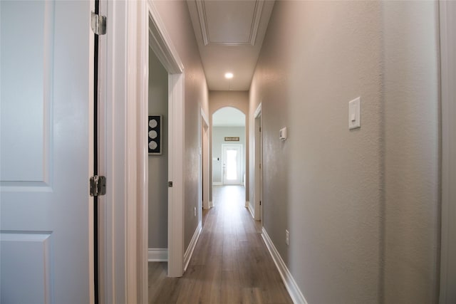 corridor with hardwood / wood-style flooring