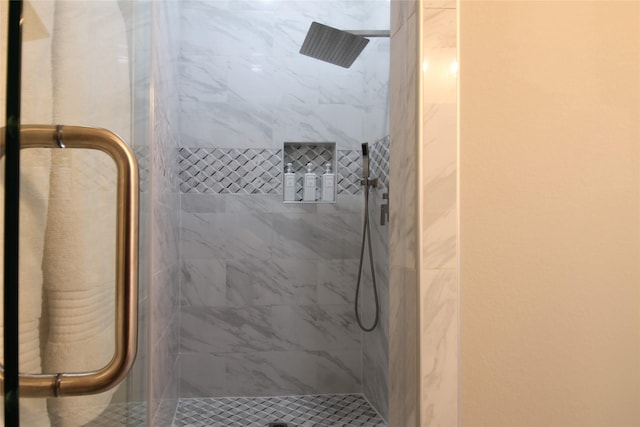 bathroom with a shower with shower door