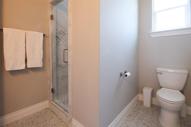 bathroom with toilet and an enclosed shower