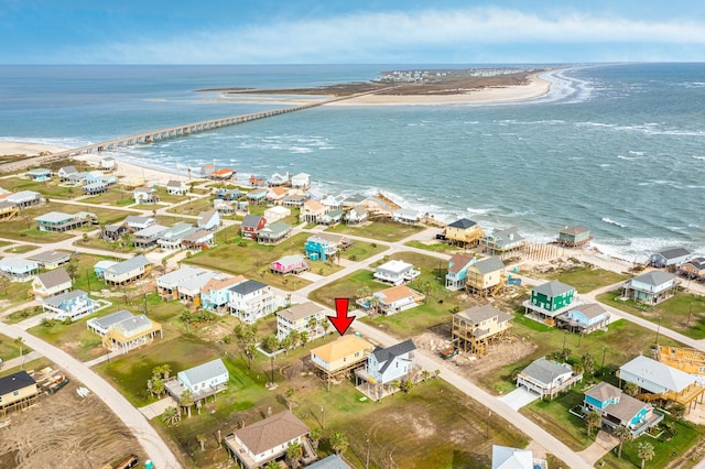 birds eye view of property featuring a water view and a beach view