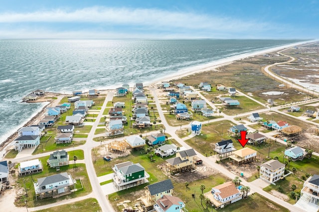 aerial view with a water view and a view of the beach