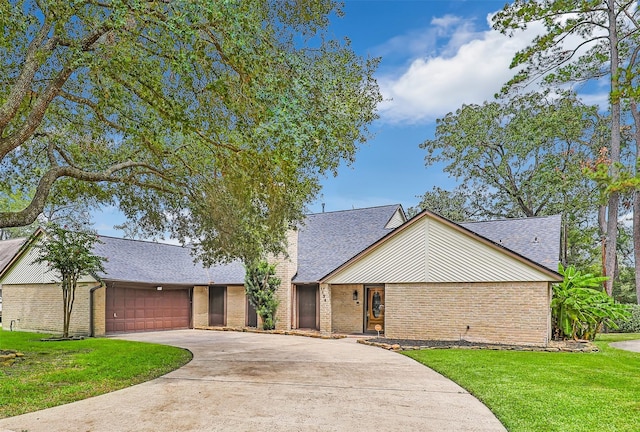 ranch-style home featuring a garage and a front yard