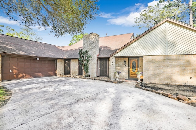 view of front of house featuring driveway, brick siding, roof with shingles, and an attached garage