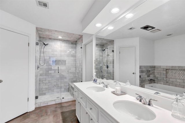 full bath featuring a bath, a stall shower, a sink, and visible vents