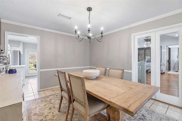 dining room featuring visible vents, ornamental molding, a notable chandelier, and light tile patterned flooring