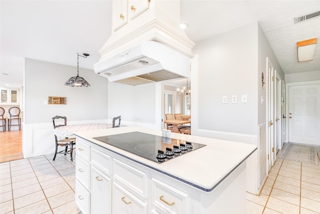 kitchen featuring light tile patterned floors, visible vents, black electric cooktop, and white cabinets