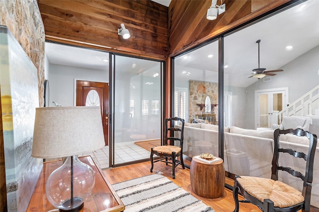 interior space featuring vaulted ceiling, wood finished floors, visible vents, and a ceiling fan