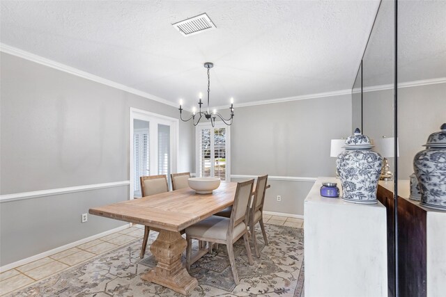 dining area with a textured ceiling, light tile patterned flooring, a notable chandelier, visible vents, and ornamental molding