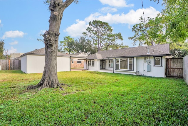 back of property featuring a yard