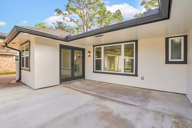 rear view of house with french doors and a patio area