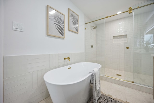 bathroom featuring separate shower and tub, tile patterned flooring, and tile walls