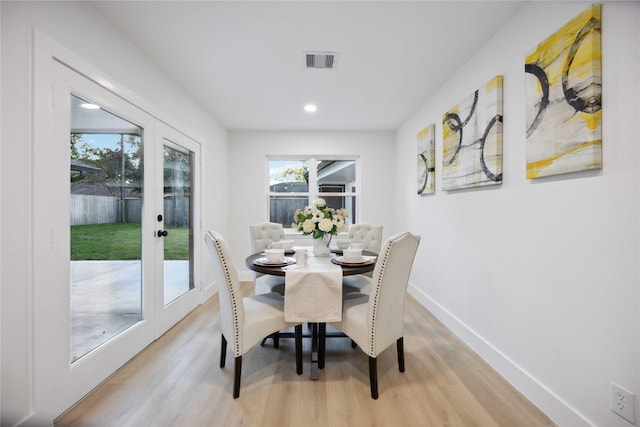 dining room featuring french doors and light hardwood / wood-style flooring