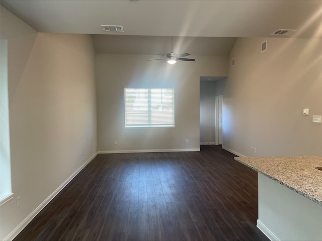 unfurnished living room featuring ceiling fan and dark hardwood / wood-style flooring