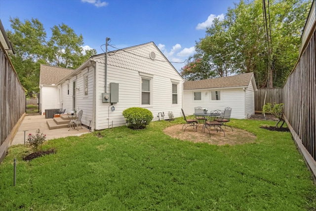 rear view of property featuring central AC unit, a patio area, and a lawn