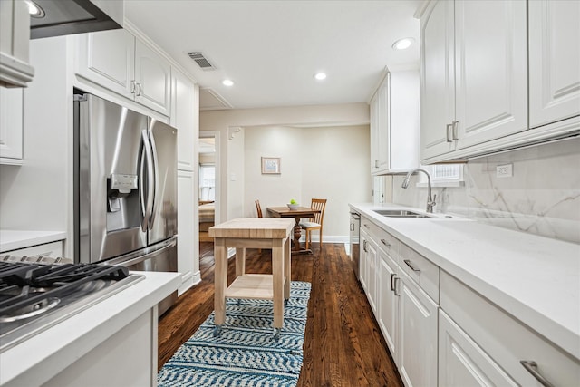 kitchen with white cabinetry, sink, appliances with stainless steel finishes, and dark wood-type flooring