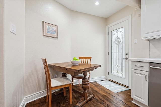 dining area with dark hardwood / wood-style flooring