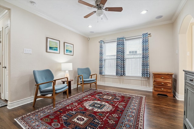 sitting room with dark hardwood / wood-style flooring, ceiling fan, and ornamental molding