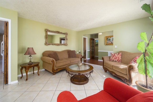 tiled living room with a textured ceiling