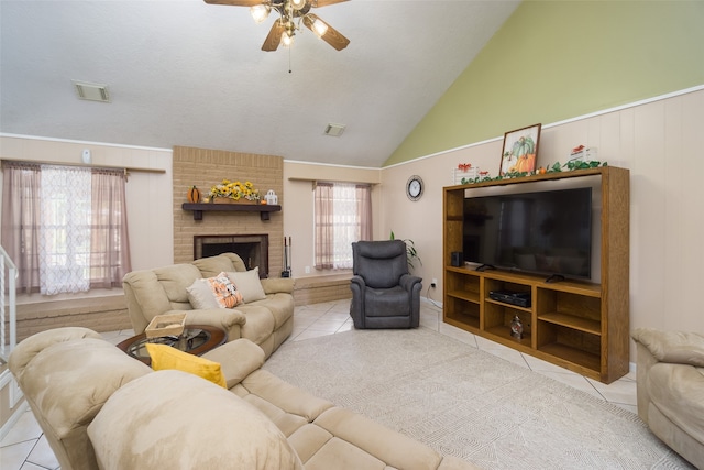 living room with plenty of natural light, light tile patterned flooring, and vaulted ceiling