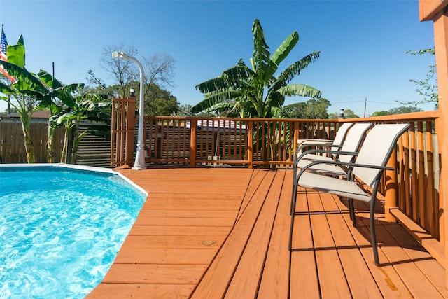 view of swimming pool with a deck