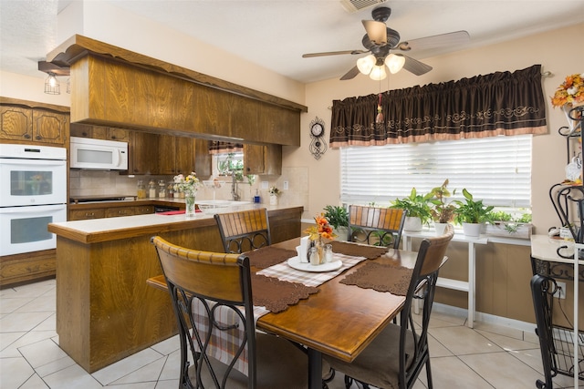 dining area featuring ceiling fan and light tile patterned floors