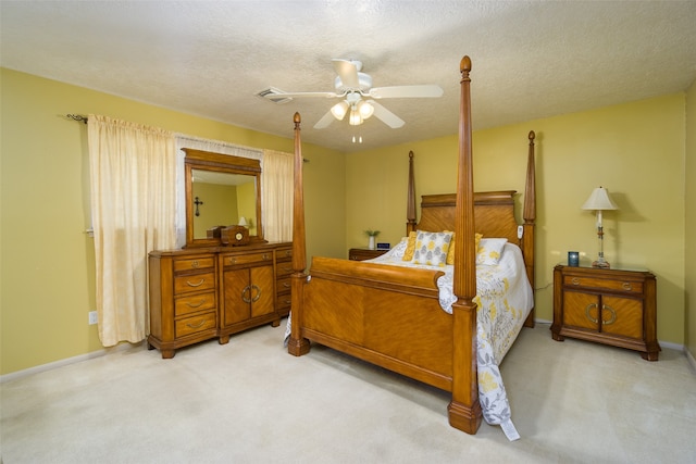 bedroom featuring ceiling fan, carpet floors, and a textured ceiling