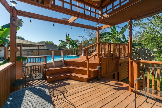 deck with a fenced in pool and a pergola