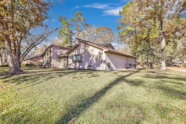 view of side of property with a lawn