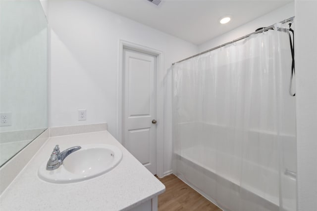 bathroom featuring vanity, shower / bath combination with curtain, and hardwood / wood-style flooring