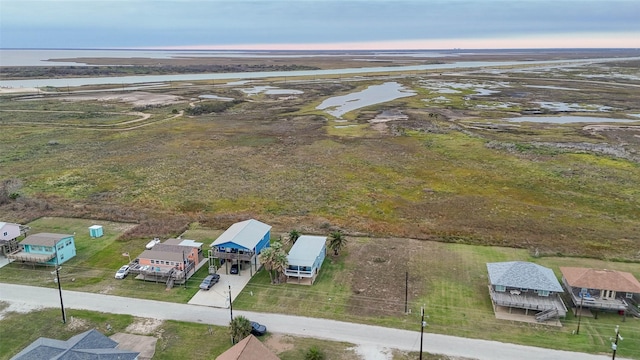 birds eye view of property with a rural view and a water view