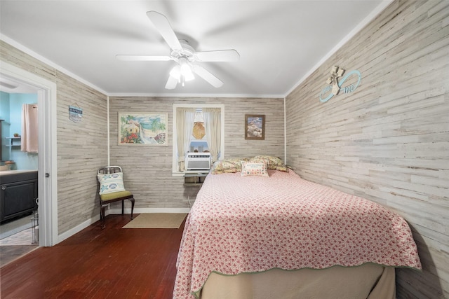 bedroom with ceiling fan, dark hardwood / wood-style floors, crown molding, and connected bathroom