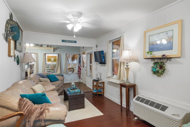 living room with a wall unit AC, ceiling fan, dark hardwood / wood-style flooring, and ornamental molding