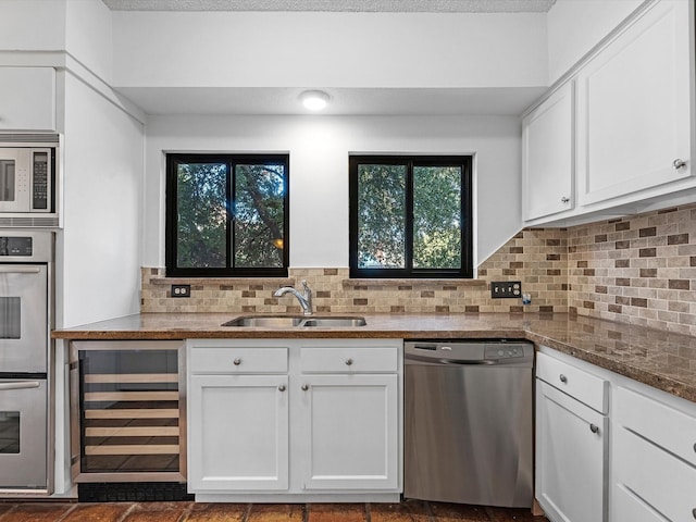 kitchen featuring wine cooler, sink, white cabinets, and stainless steel appliances