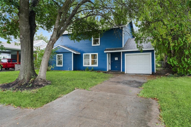 view of front of house featuring a front lawn and a garage