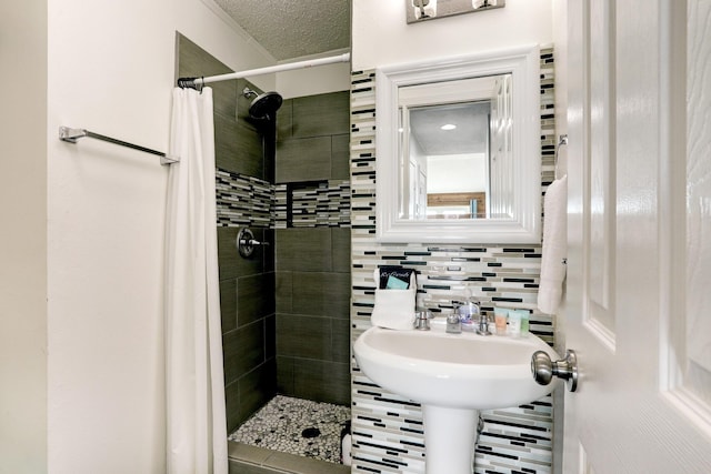 bathroom with tasteful backsplash, a textured ceiling, and walk in shower