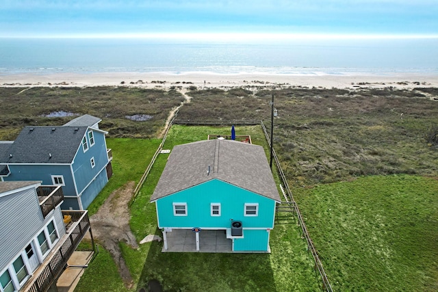 birds eye view of property with a beach view and a water view