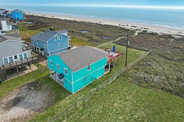 drone / aerial view featuring a water view and a beach view