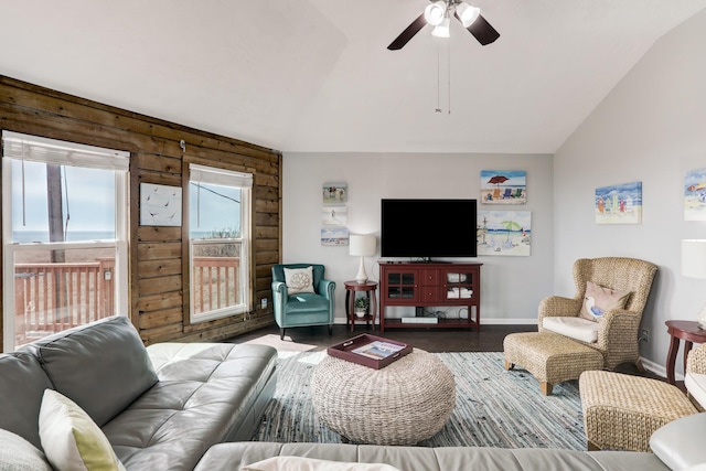 living room featuring ceiling fan, dark hardwood / wood-style floors, and vaulted ceiling