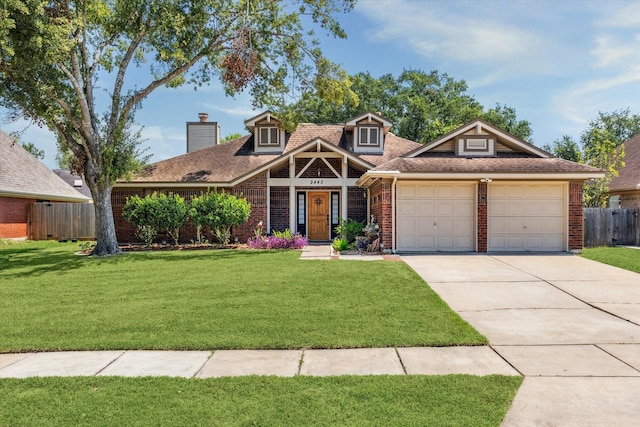 view of front of house featuring a front yard and a garage