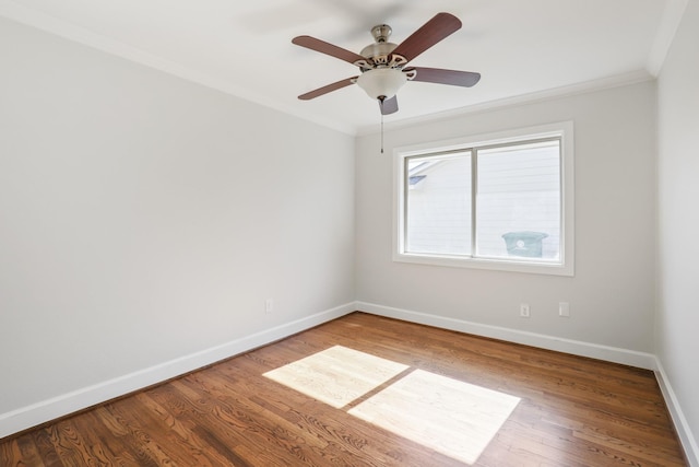 spare room featuring hardwood / wood-style flooring, ceiling fan, and ornamental molding