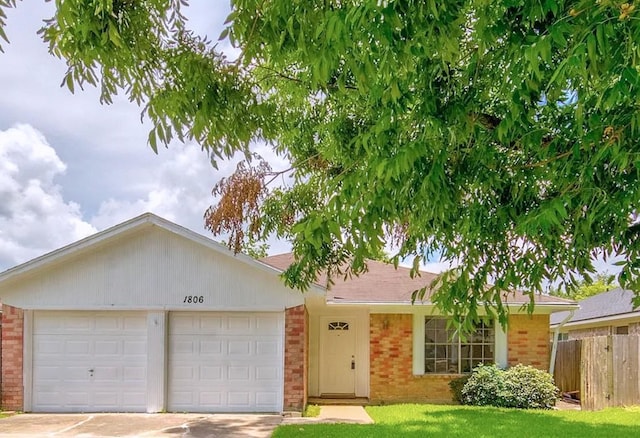 single story home with a garage and a front lawn