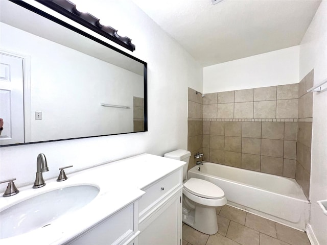 full bathroom with vanity, tile patterned flooring, tiled shower / bath combo, and toilet