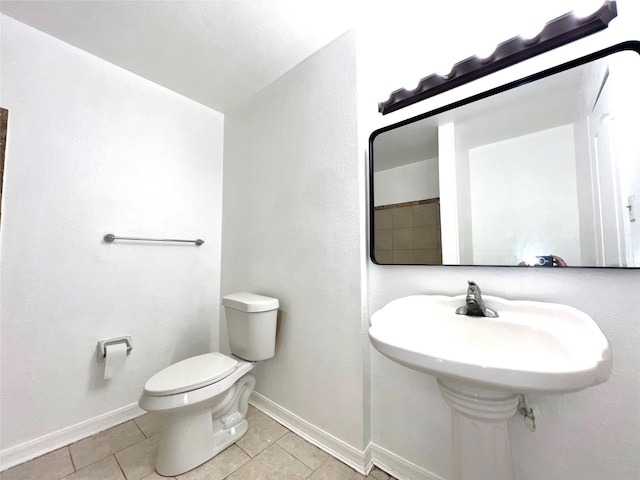 bathroom with tile patterned flooring and toilet