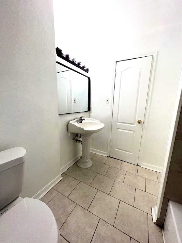 bathroom featuring tile patterned floors and toilet