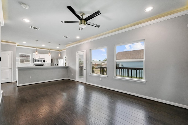 unfurnished living room featuring dark hardwood / wood-style flooring, ceiling fan, ornamental molding, and sink