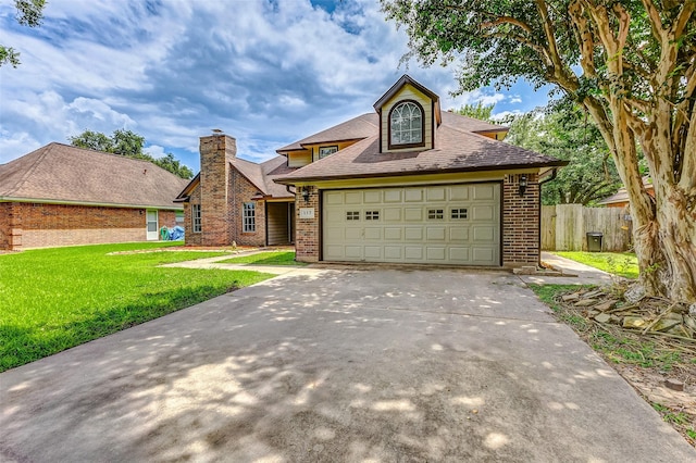 view of front of property featuring a front yard and a garage