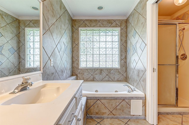 bathroom featuring tile patterned floors, vanity, crown molding, tile walls, and shower with separate bathtub