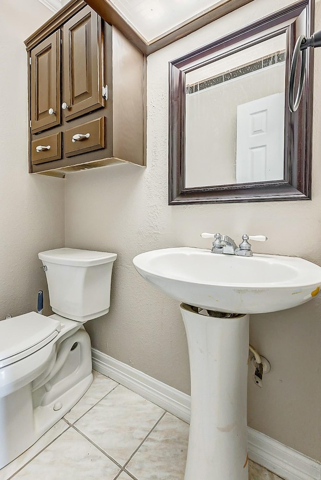 bathroom featuring tile patterned flooring and toilet