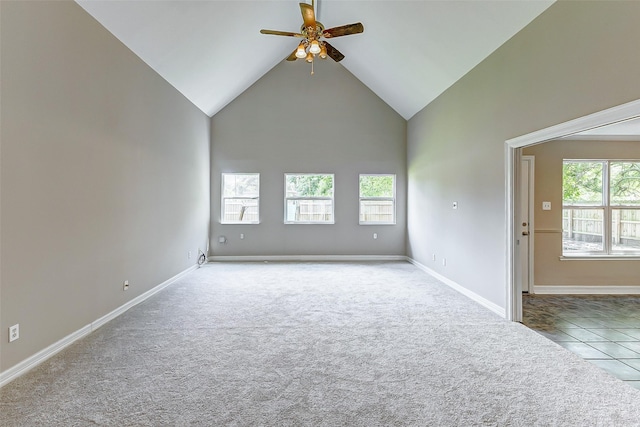 unfurnished living room with light carpet, high vaulted ceiling, ceiling fan, and a healthy amount of sunlight