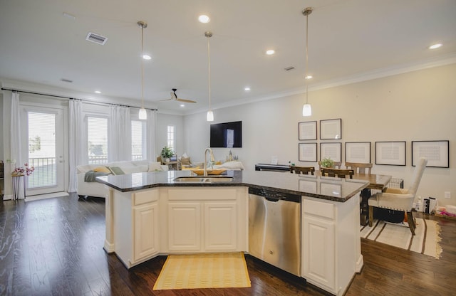 kitchen featuring dishwasher, hanging light fixtures, a center island with sink, and sink